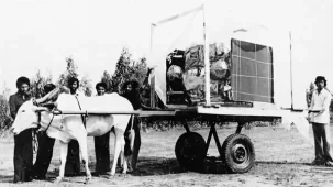 ISRO engineer riding a bicycle carrying a rocket part, showcasing India's early space program efforts